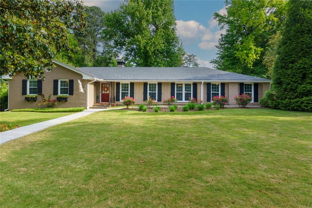 690 Glenforest Road Atlanta, GA 30328 - Photo 1 of 1 a front view of house with yard and green space
