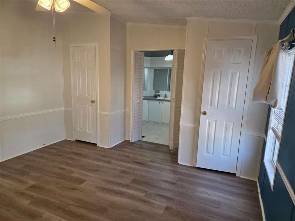 145 Rock Forge Court Jefferson, GA 30549 - Photo 11 of 22 an empty room with wooden floor and a bathroom