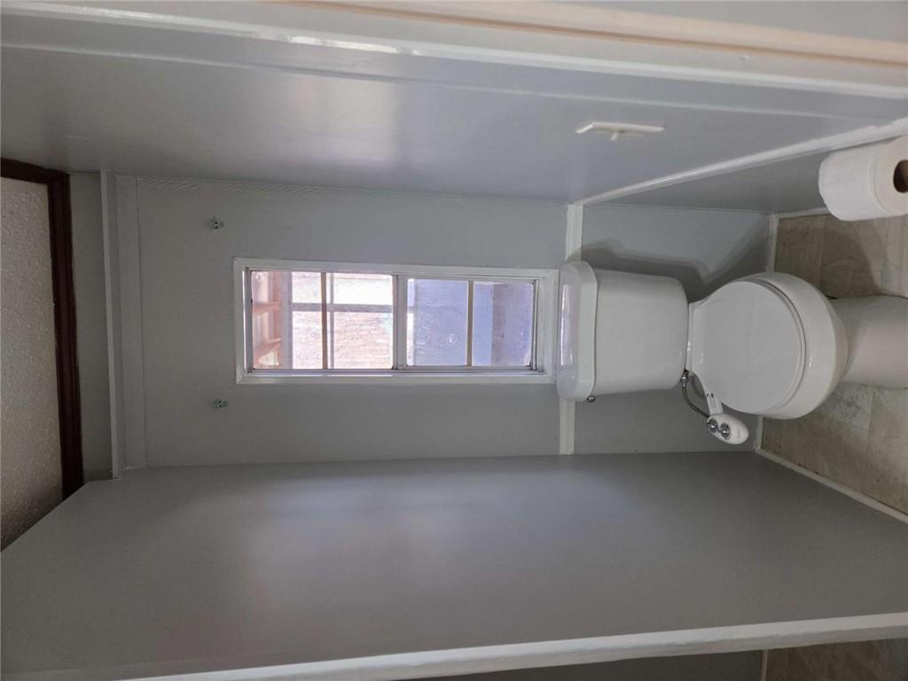 145 Rock Forge Court Jefferson, GA 30549 - Photo 12 of 22 a white toilet sitting next to a window