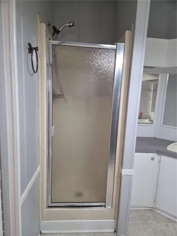 an entryway with wooden floor and a cabinet