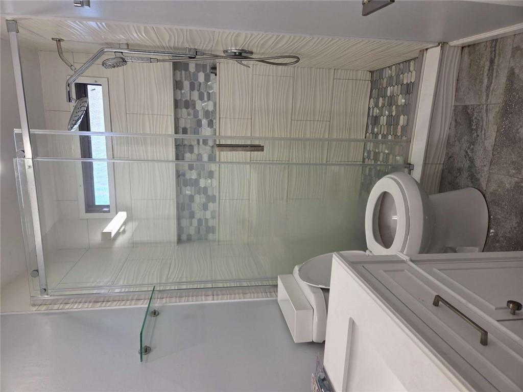 145 Rock Forge Court Jefferson, GA 30549 - Photo 17 of 22 a bathroom with a toilet and shower