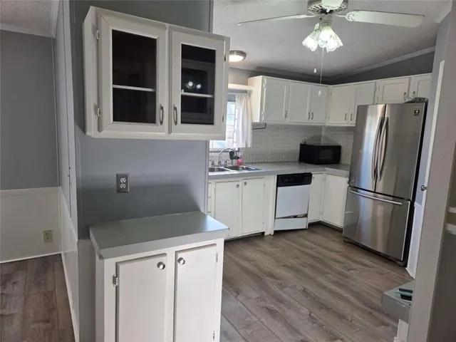 a kitchen with stainless steel appliances a refrigerator sink and cabinets