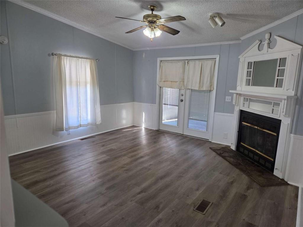 145 Rock Forge Court Jefferson, GA 30549 - Photo 7 of 22 a view of a livingroom with a fireplace a ceiling fan and wooden floor