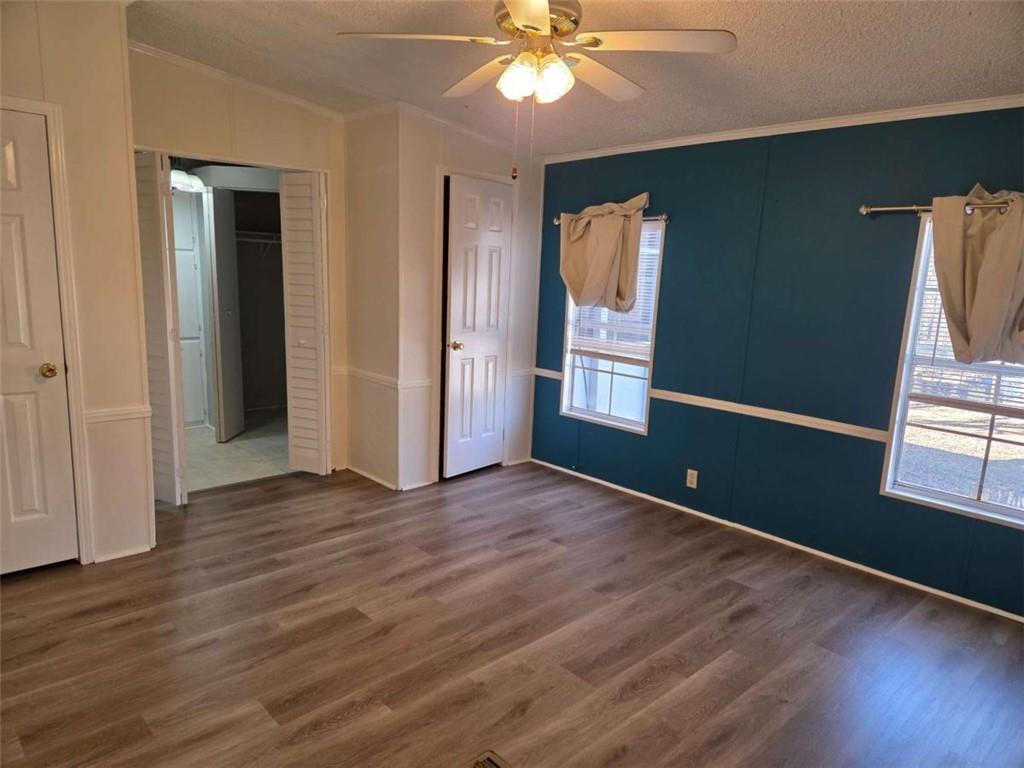 145 Rock Forge Court Jefferson, GA 30549 - Photo 10 of 22 an empty room with wooden floor fan and windows