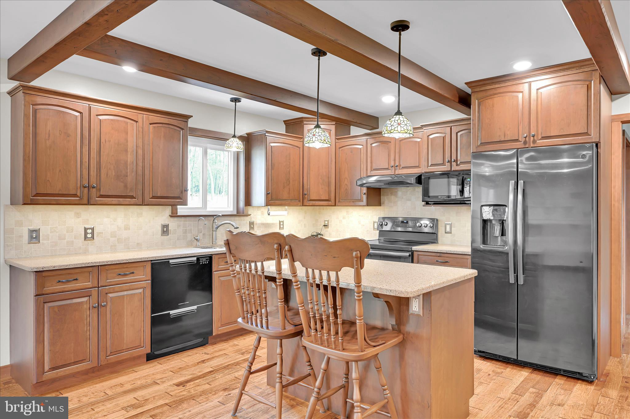 643 Deturksville Road Pine Grove, PA 17963 - Photo 30 of 59 a kitchen with stainless steel appliances granite countertop a sink a stove a refrigerator cabinets and chairs