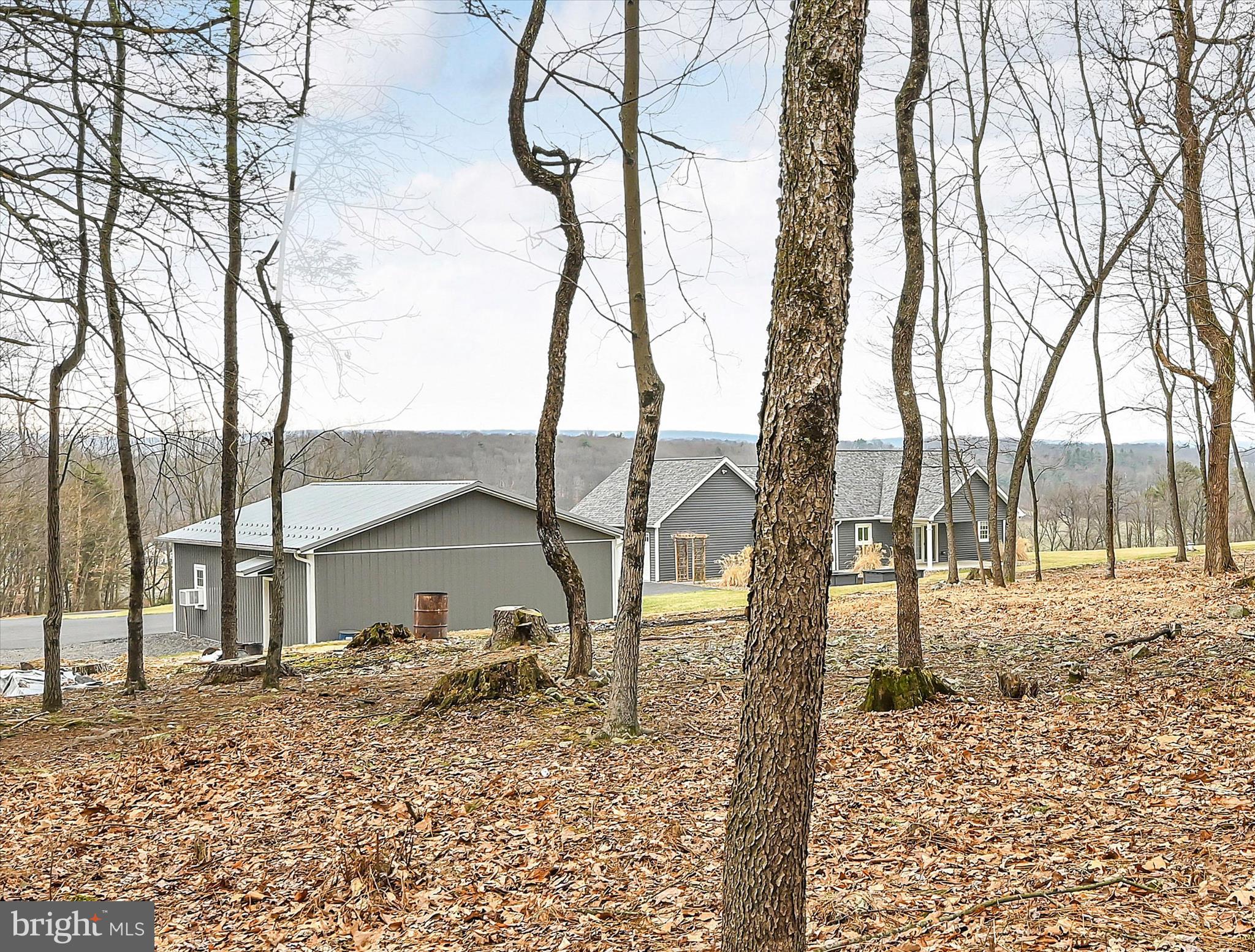 643 Deturksville Road Pine Grove, PA 17963 - Photo 46 of 59 a backyard of a house with large trees and wooden fence