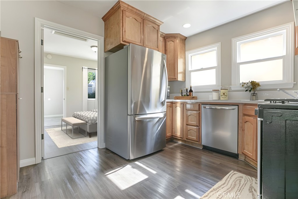 10404 Leolang Avenue Sunland, CA 91040 - Photo 16 of 37 a kitchen with a refrigerator a sink and wooden floor