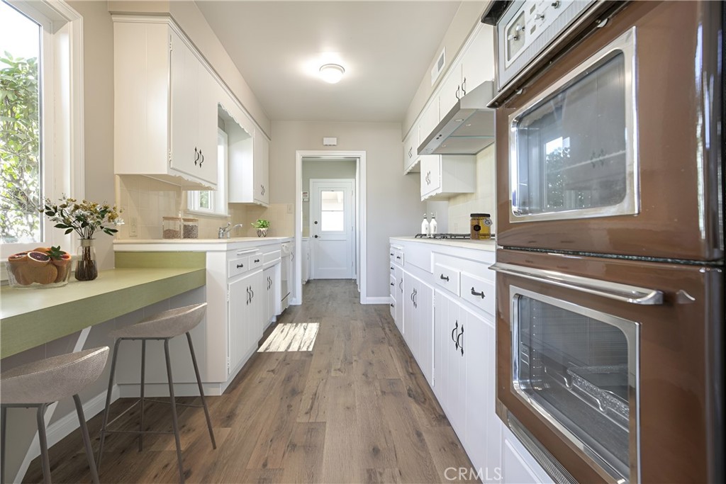 10404 Leolang Avenue Sunland, CA 91040 - Photo 6 of 37 a large white kitchen with cabinets a sink and appliances