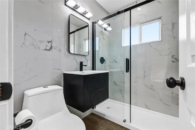 a bathroom with a toilet sink and shower