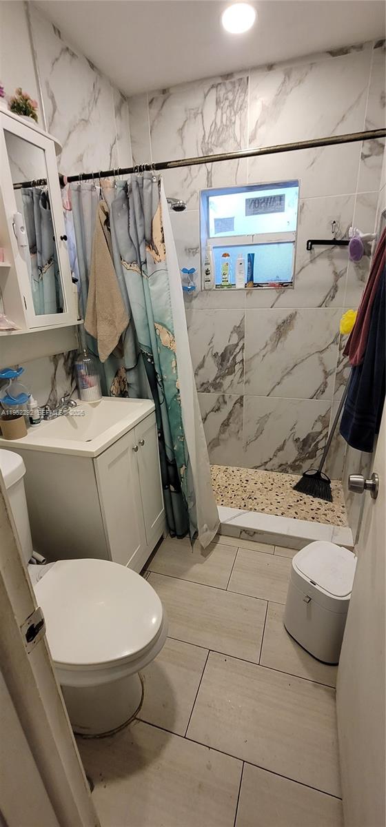 3621 Southwest 13th Street Miami, FL 33145 - Photo 2 of 9 a white toilet sitting next to a bathroom sink