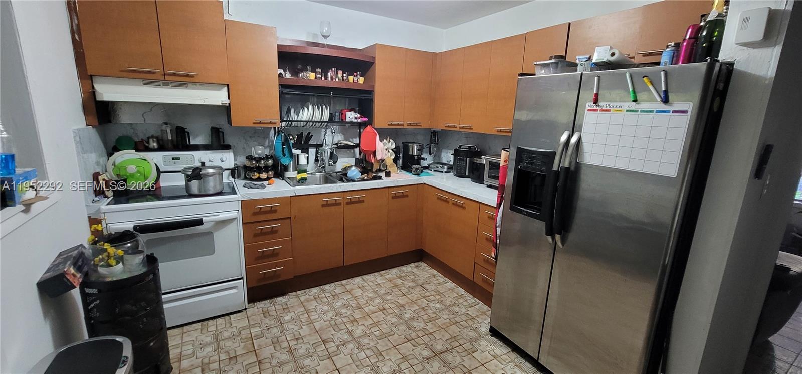 3621 Southwest 13th Street Miami, FL 33145 - Photo 8 of 9 a kitchen with refrigerator and cabinets