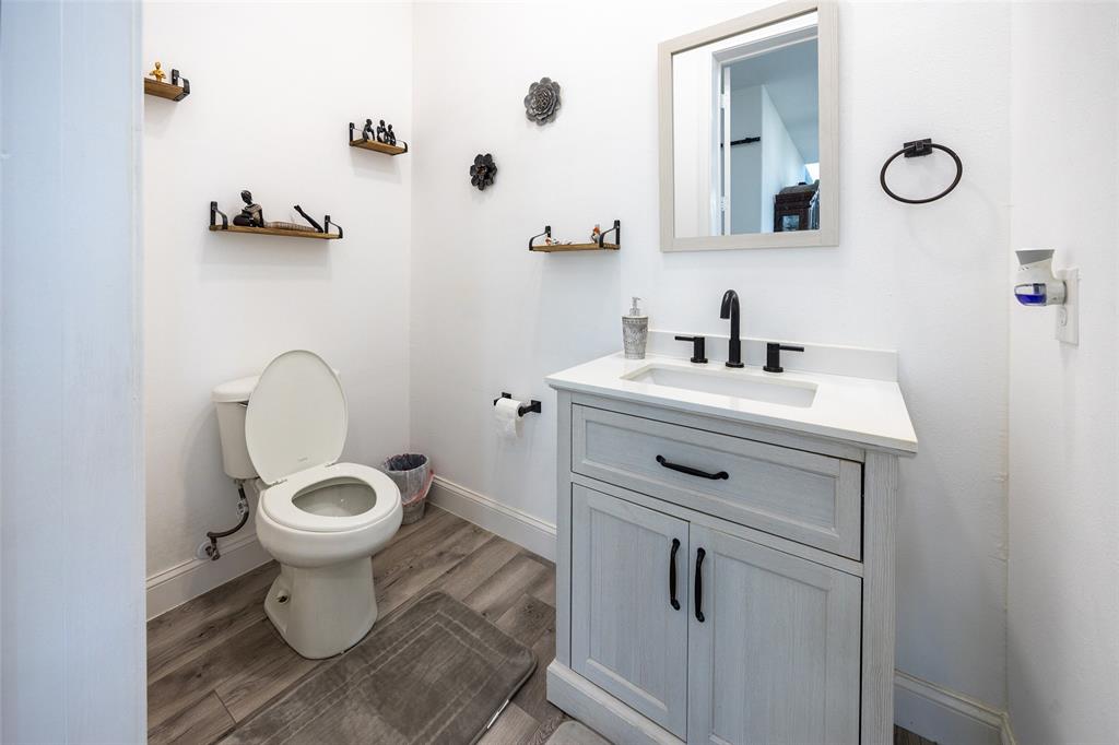 2630 Rockhill Road Aubrey, TX 76227 - Photo 22 of 36 a bathroom with a sink toilet and a mirror