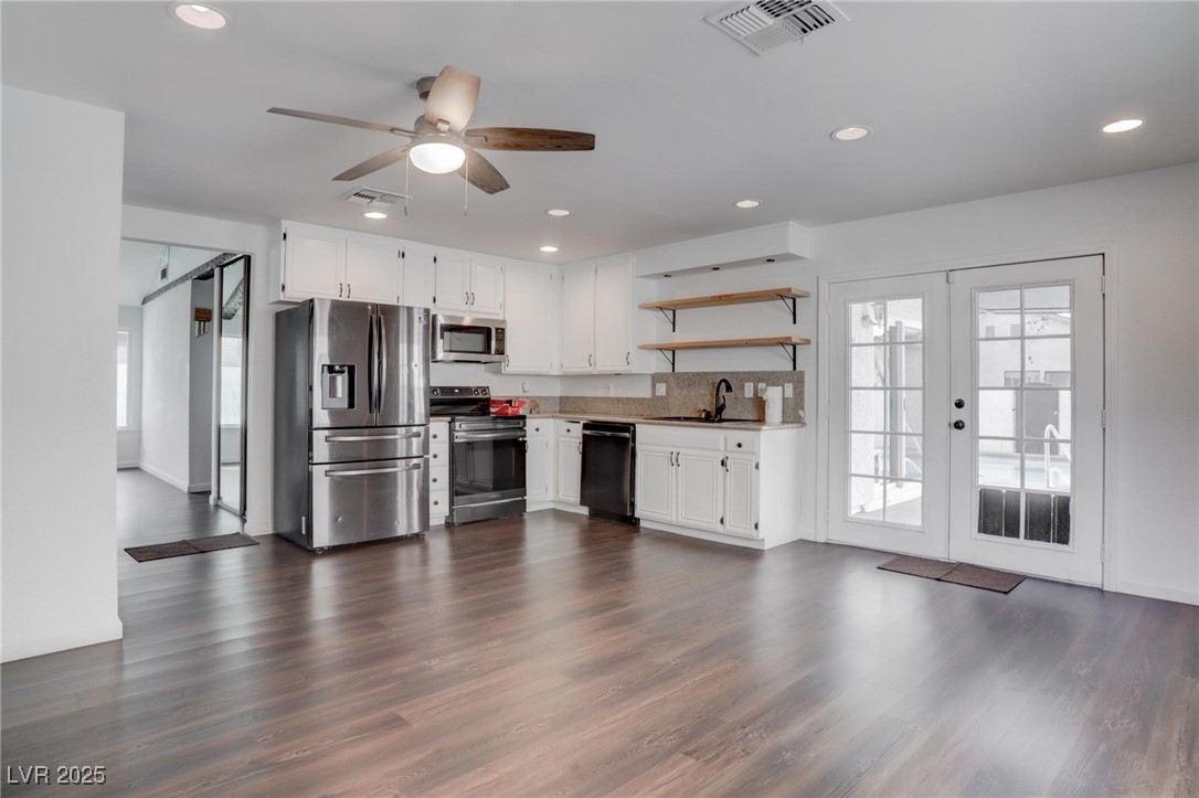 4775 Monaco Road Las Vegas, NV 89121 - Photo 20 of 31 Kitchen featuring french doors, white cabinets, stainless steel appliances, and dark hardwood / wood-style flooring