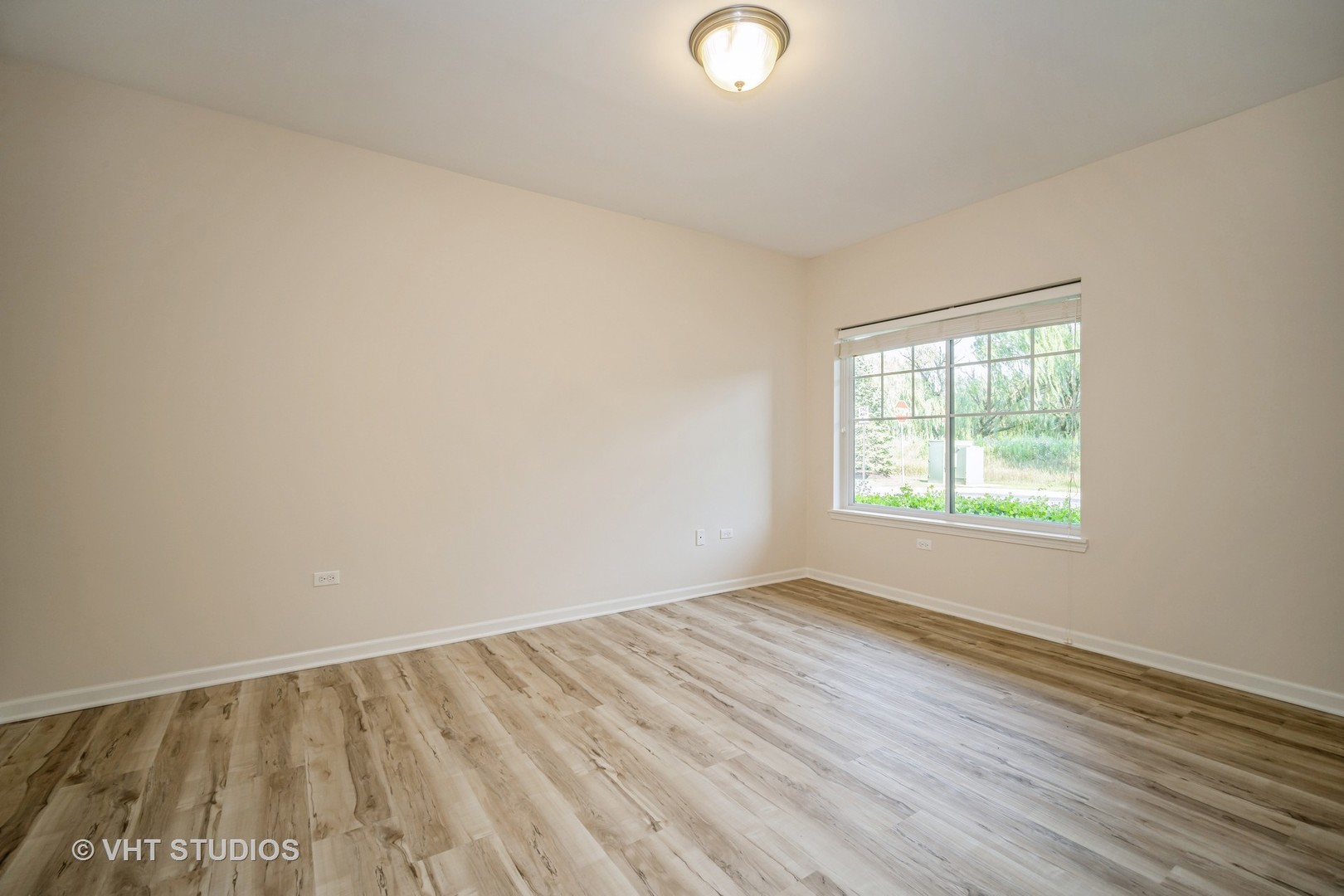 2220 Founders Way, Unit P102 Northbrook, IL 60062 - Photo 11 of 23 an empty room with wooden floor and windows