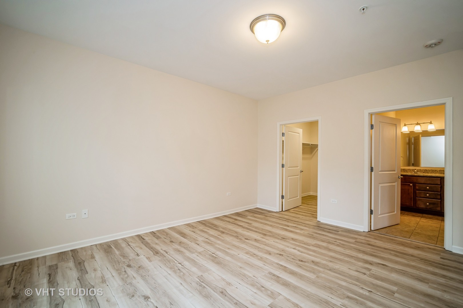 2220 Founders Way, Unit P102 Northbrook, IL 60062 - Photo 12 of 23 wooden floor in an empty room with a window