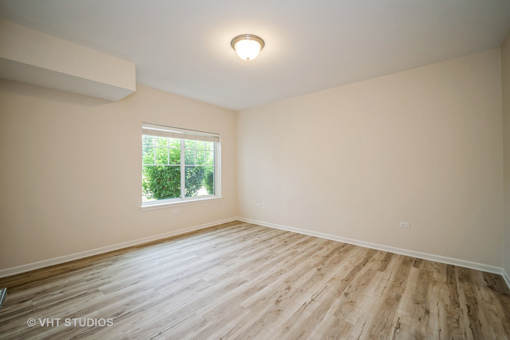 2220 Founders Way, Unit P102 Northbrook, IL 60062 - Photo 16 of 23 wooden floor in an empty room with a window