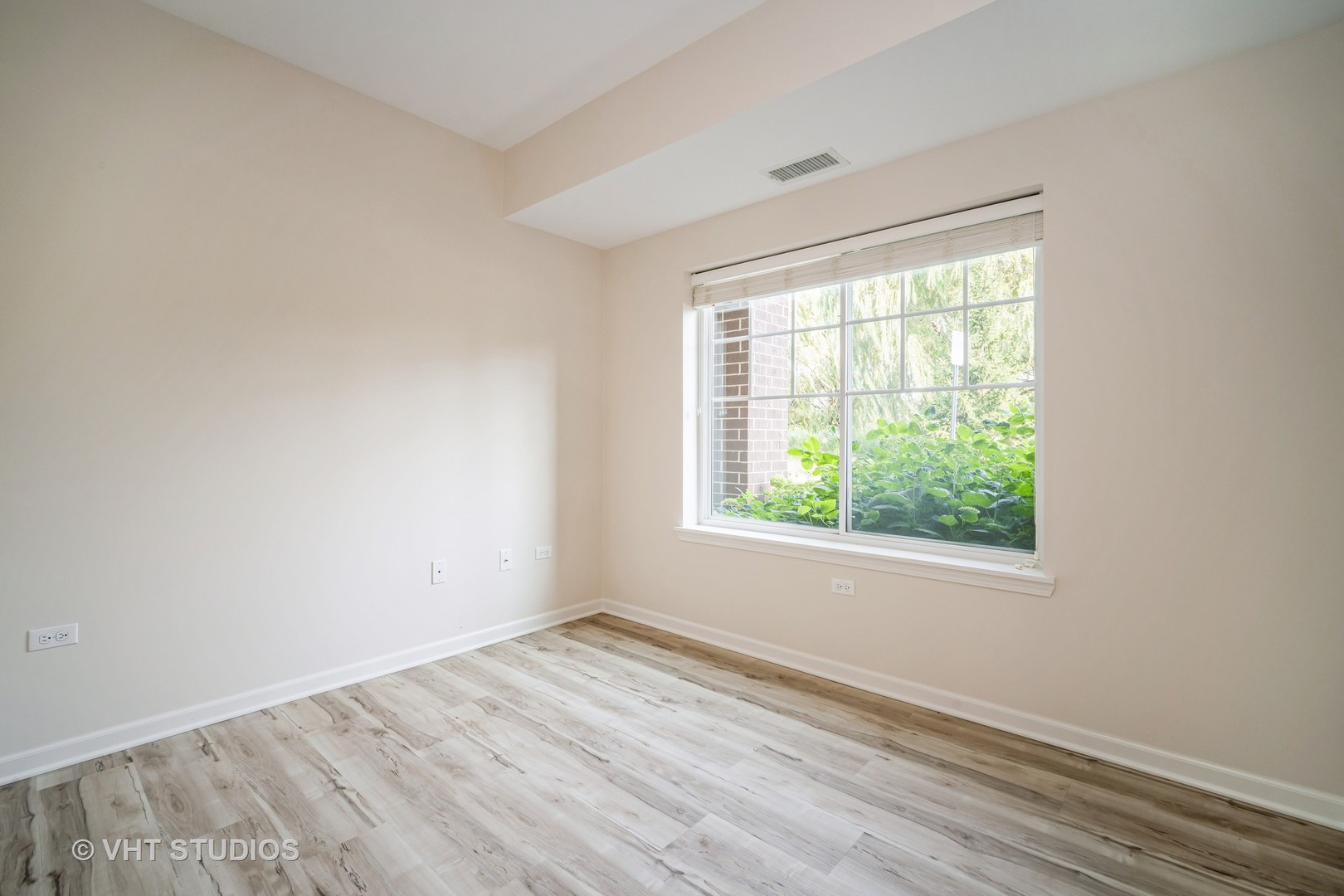 2220 Founders Way, Unit P102 Northbrook, IL 60062 - Photo 18 of 23 an empty room with wooden floor and windows