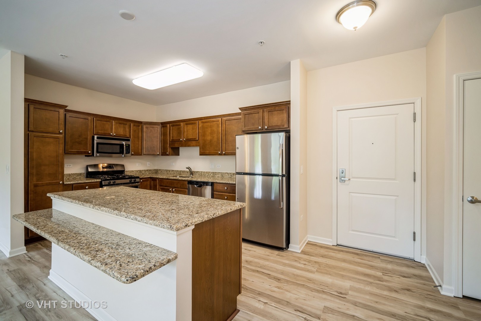 2220 Founders Way, Unit P102 Northbrook, IL 60062 - Photo 5 of 23 a kitchen with stainless steel appliances granite countertop a refrigerator stove microwave and sink