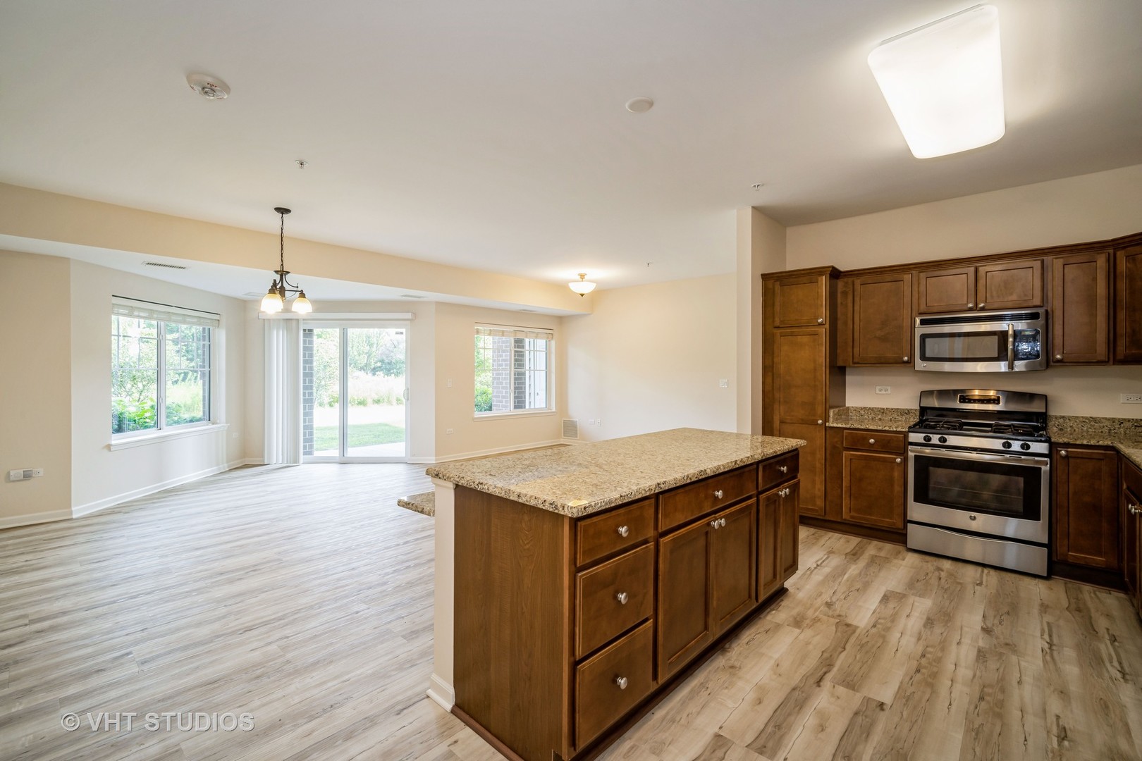 2220 Founders Way, Unit P102 Northbrook, IL 60062 - Photo 6 of 23 a kitchen with stainless steel appliances granite countertop a stove a sink and a microwave