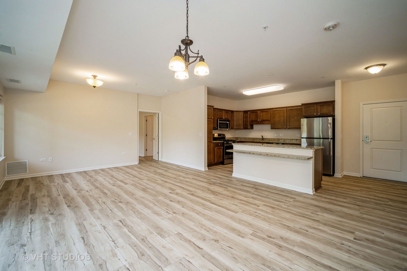 2220 Founders Way, Unit P102 Northbrook, IL 60062 - Photo 7 of 23 a view of a kitchen with a stove cabinets and wooden floor