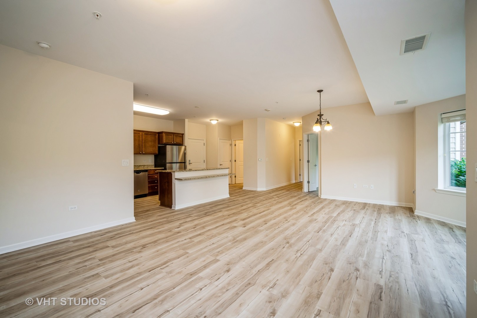 2220 Founders Way, Unit P102 Northbrook, IL 60062 - Photo 9 of 23 a view of a kitchen with a sink and a refrigerator