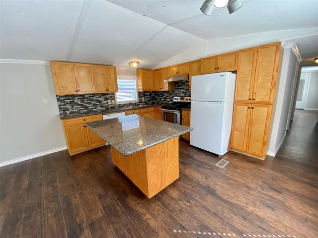 a kitchen with wooden floors and a stove
