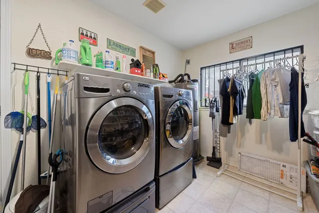 a kitchen with stainless steel appliances kitchen island granite countertop a refrigerator a stove a sink dishwasher and a refrigerator with wooden floor