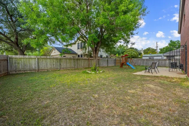 a view of a house with backyard and a slide