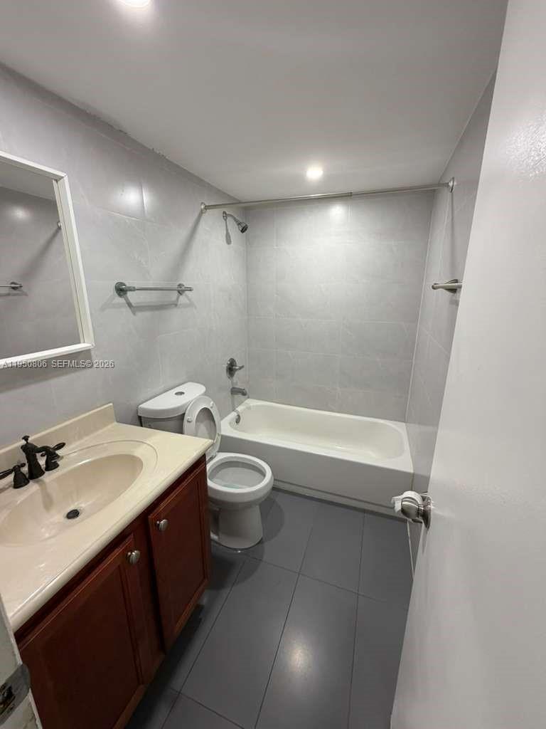 6980 Northwest 186th Street, Unit 3321 Hialeah, FL 33015 - Photo 4 of 10 a bathroom with a sink a toilet and shower
