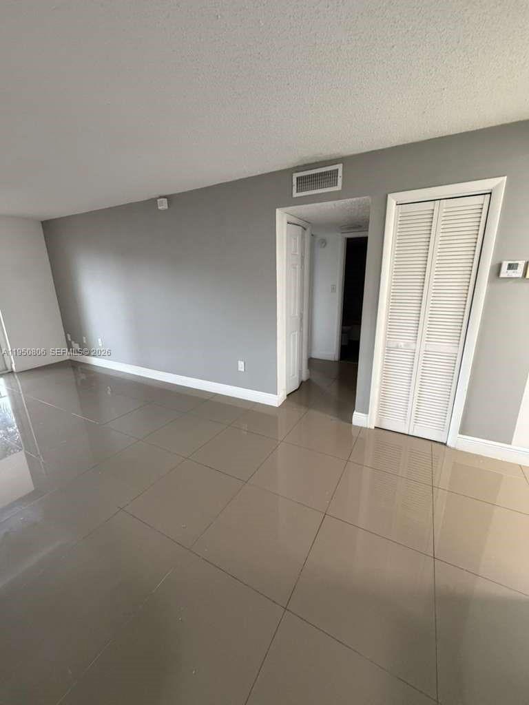 6980 Northwest 186th Street, Unit 3321 Hialeah, FL 33015 - Photo 6 of 10 a view of an empty room with a window