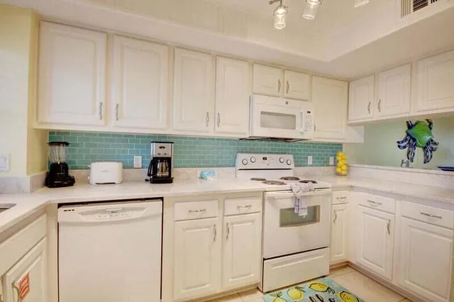 a kitchen with cabinets appliances and a sink