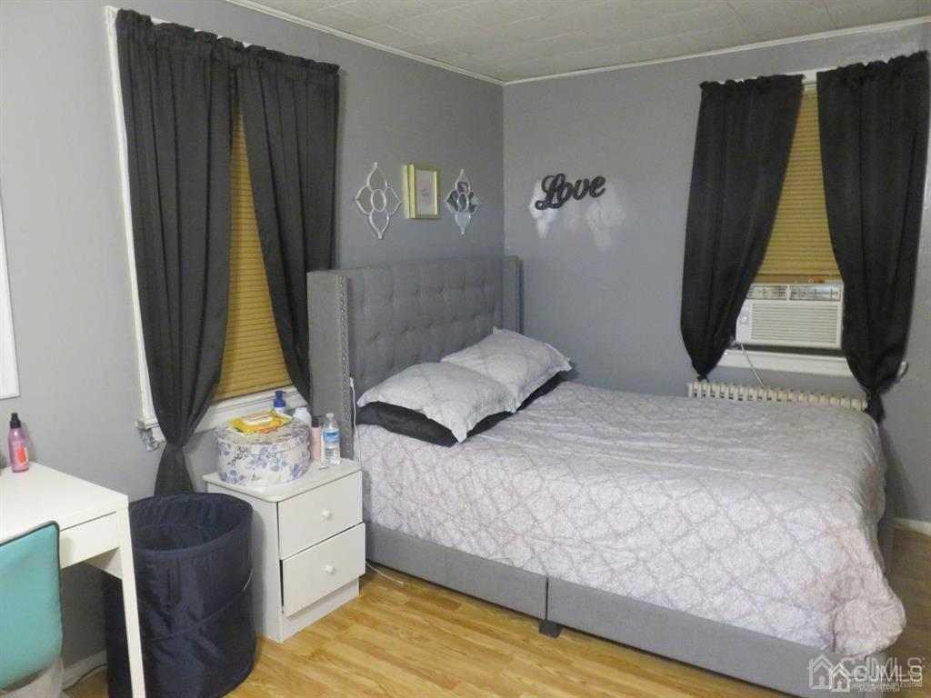 367 Eagle Avenue Perth Amboy, NJ 08861 - Photo 22 of 25 a bedroom with a bed and a dresser