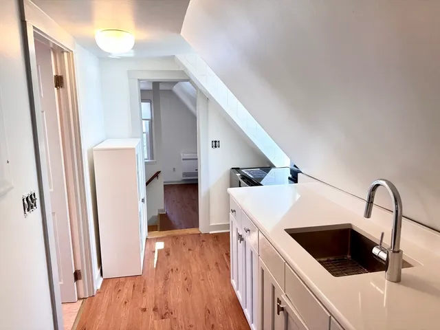 a kitchen with a sink a refrigerator and cabinets