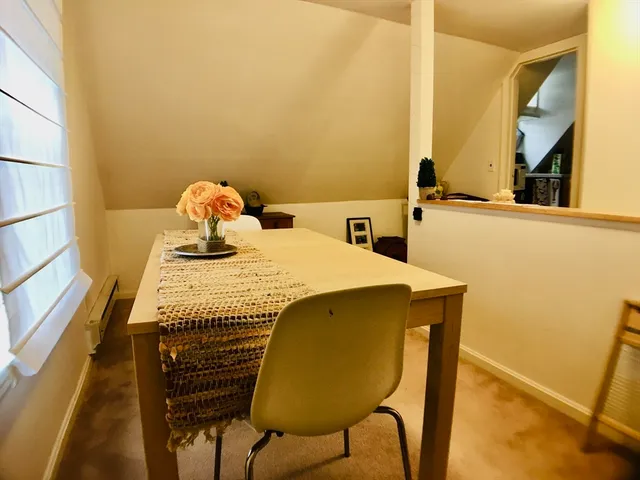 a bedroom with a bed and teddy bear on bed