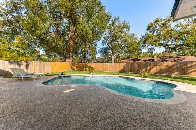 a view of a backyard with swimming pool