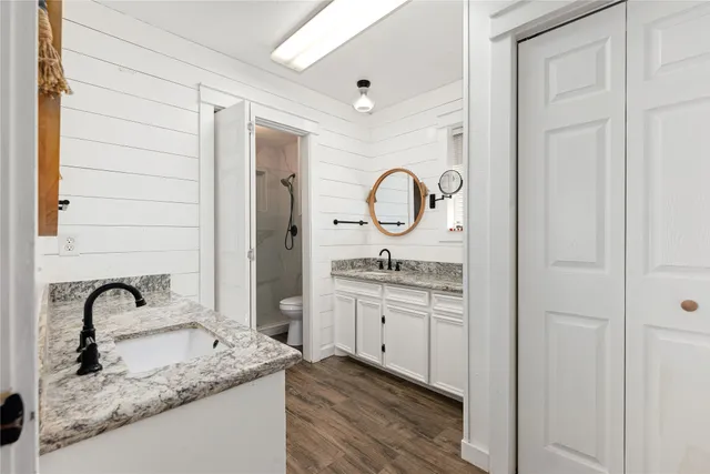 a bathroom with a granite countertop sink and a mirror