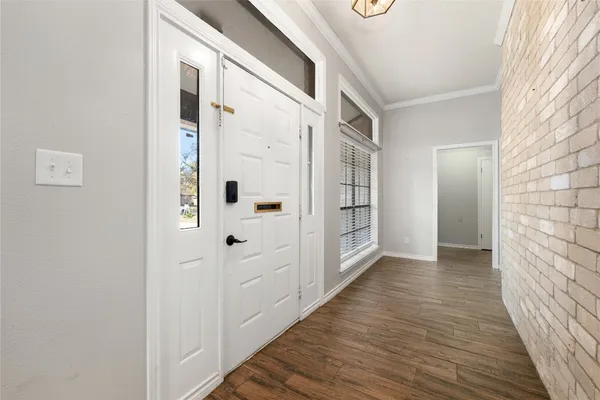 a view of a hallway with wooden floor and closet area
