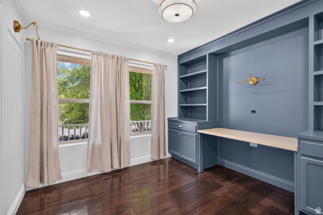 2223 North Pointe Meadow Loop Lehi, UT 84048 - Photo 6 of 56 Room featuring extensive built-in cabinetry and shelving in a matte blue finish, integrated desk space, recessed lighting, and wood-finish flooring