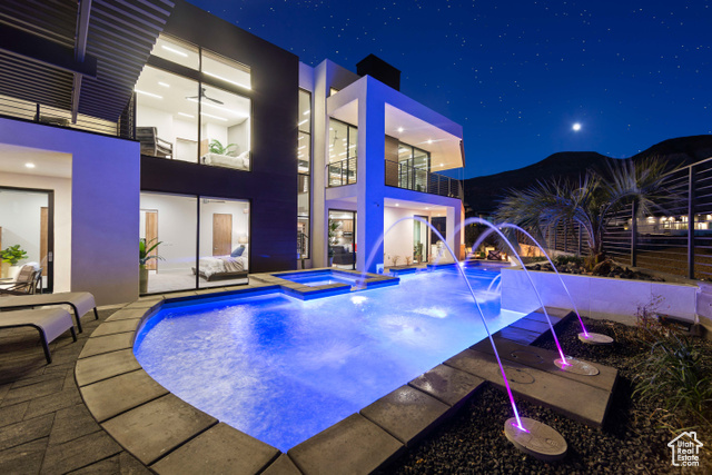 3558 South Cypress Road Hurricane, UT 84737 - Photo 41 of 57 Pool at twilight featuring pool water feature and a patio area
