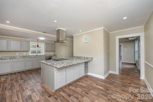 a kitchen with stainless steel appliances granite countertop a stove and a sink