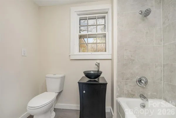 a bathroom with a toilet sink shower and bathtub