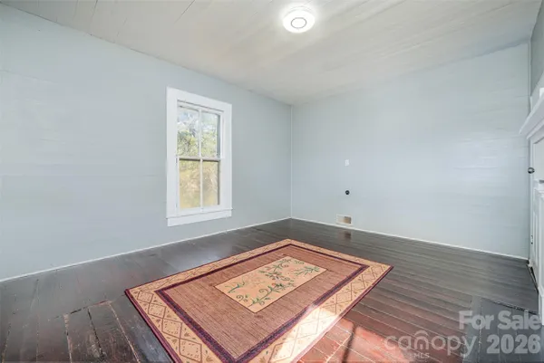 an empty room with wooden floor