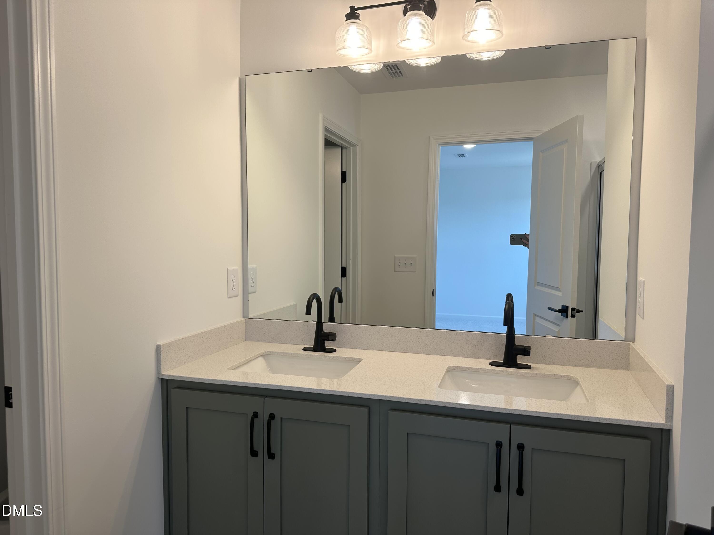 1526 Mirth Court Rolesville, NC 27571 - Photo 24 of 34 a bathroom with a sink and a mirror