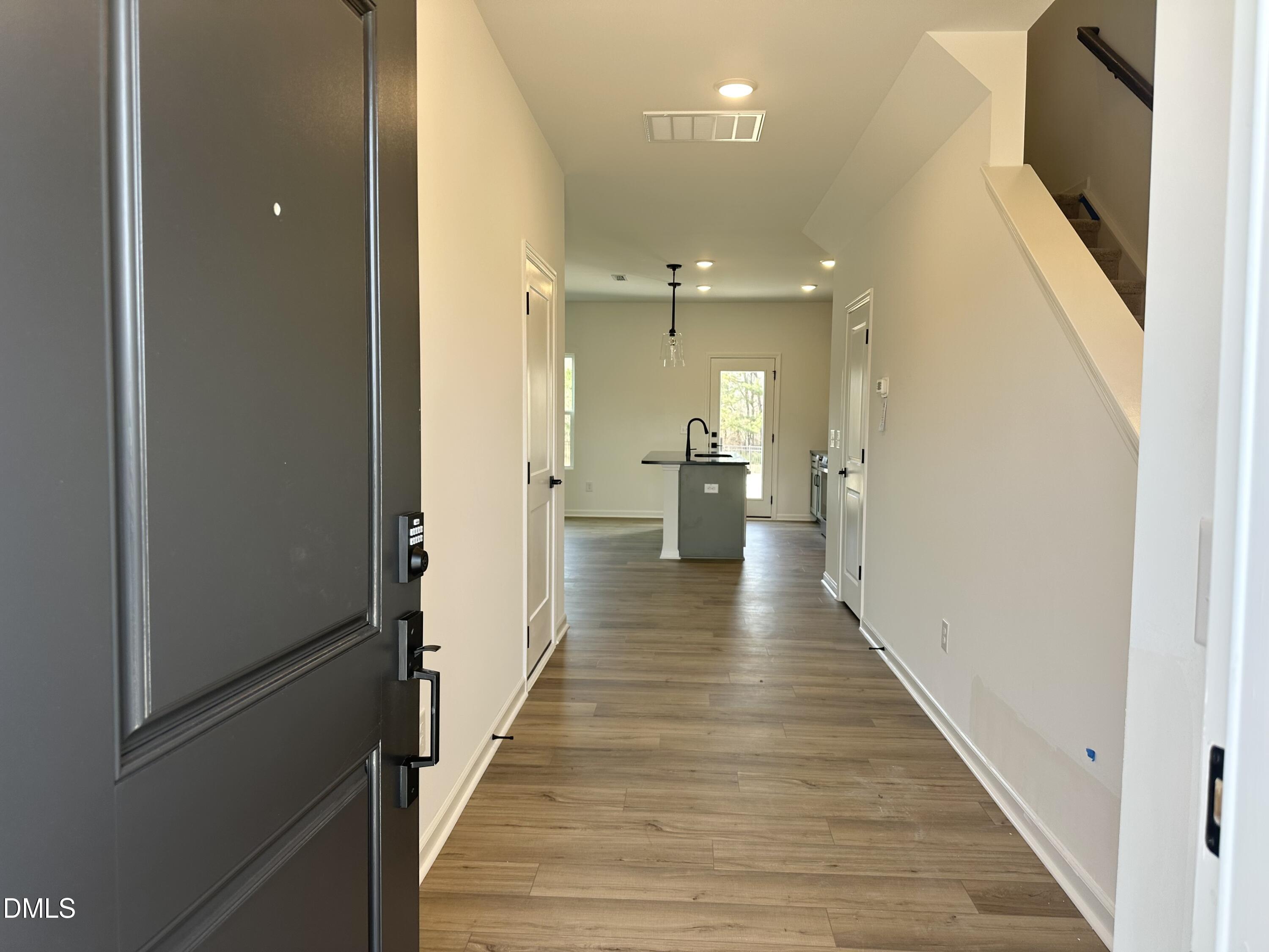 1526 Mirth Court Rolesville, NC 27571 - Photo 4 of 34 a view of a hallway with wooden floor