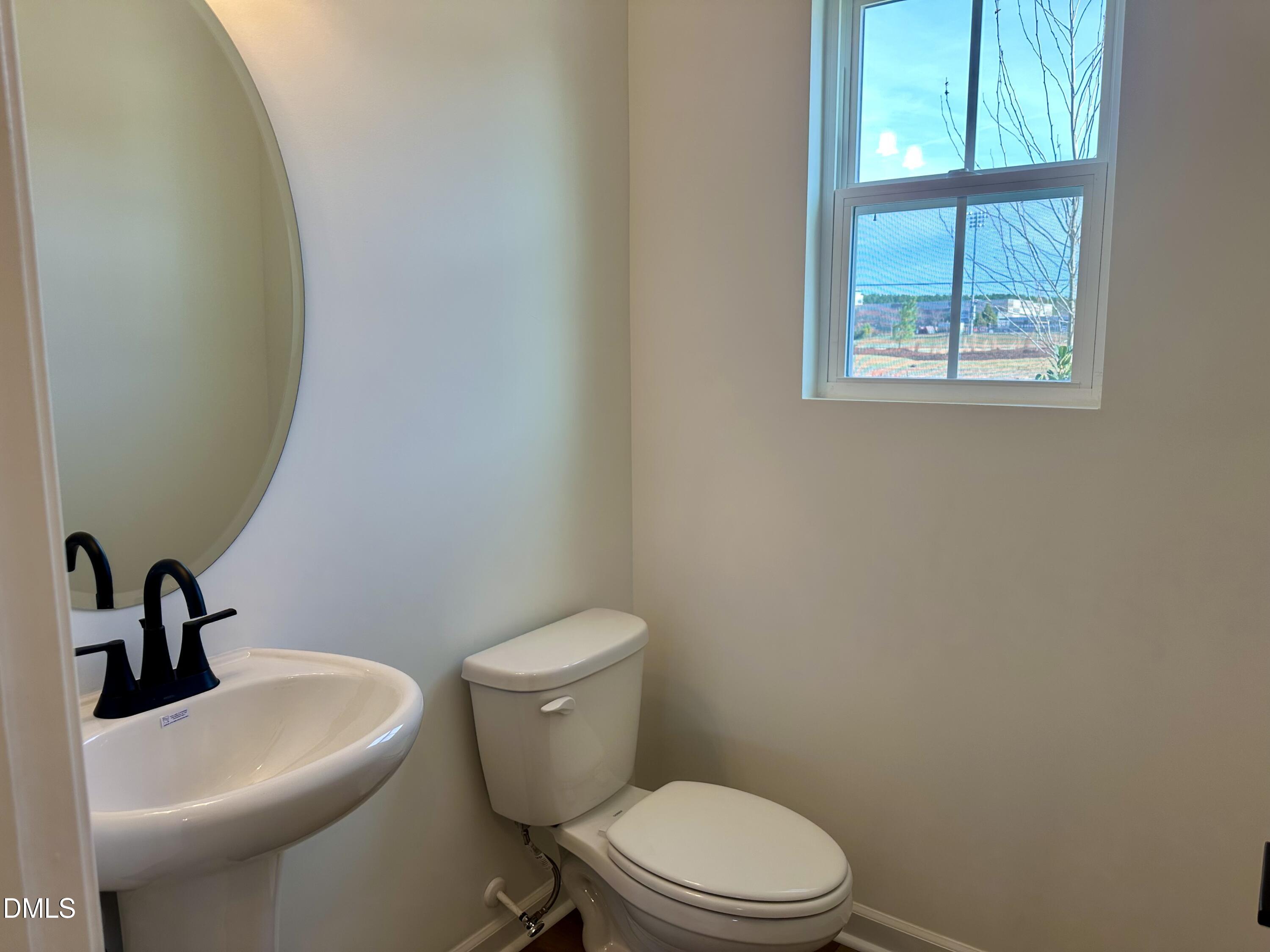 1526 Mirth Court Rolesville, NC 27571 - Photo 6 of 34 a white toilet sitting next to a bathroom sink