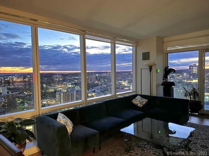 1 Broad Street, Unit PH23A Stamford, CT 06901 - Photo 1 of 1 a living room with furniture and a floor to ceiling window