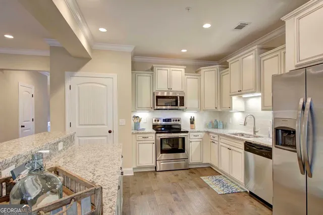 a kitchen with cabinets and stainless steel appliances