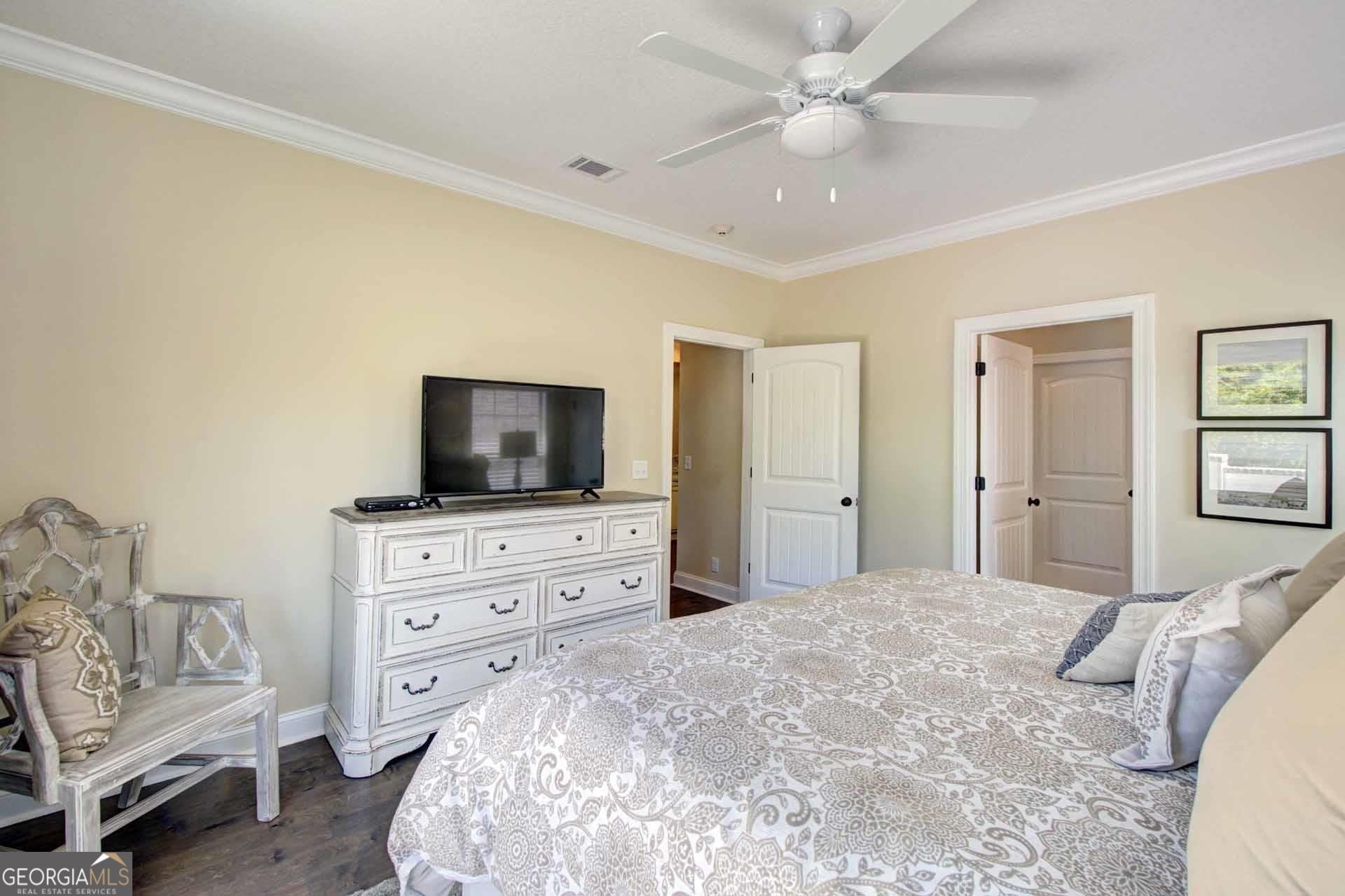 205 Mariners Circle St. Simons, GA 31522 - Photo 16 of 51 a bedroom with a bed flat screen tv and a couch