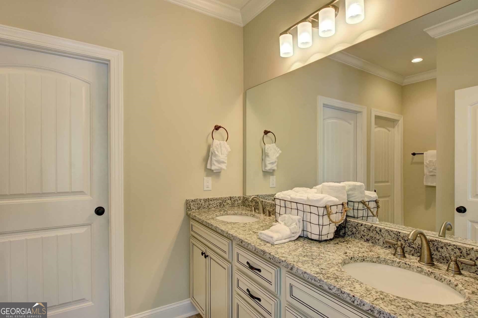 205 Mariners Circle St. Simons, GA 31522 - Photo 17 of 51 a bathroom with a granite countertop sink and a mirror