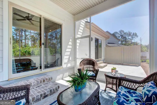 a dining room with furniture a floor to ceiling window and wooden floor